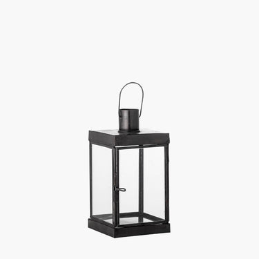 Black metal lantern with glass panels and hook handle on white background