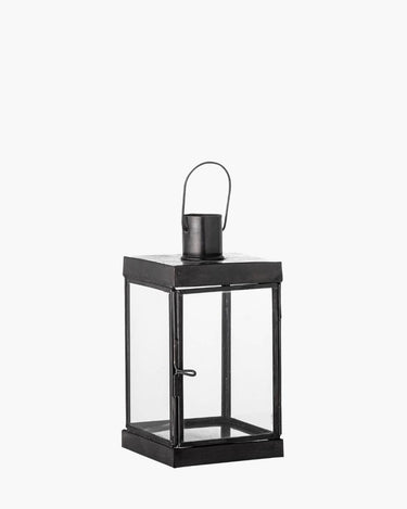 Black metal lantern with glass panels and hook handle on white background