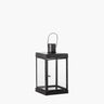 Black metal lantern with glass panels and hook handle on white background