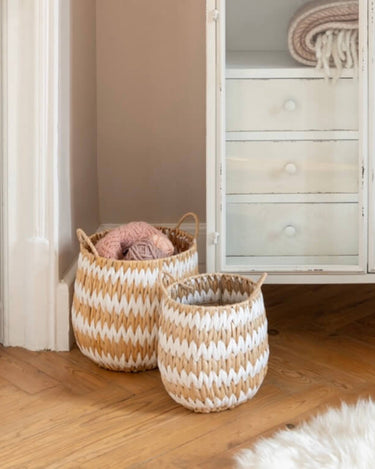 Hand woven natural and white basket in lifestyle photo