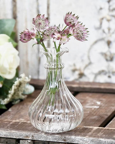 Glass bud vase with ribbed etching in lifestyle photo