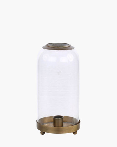 Glass bell and bronze candle holder on feet on white background