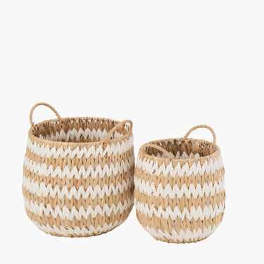 Hand woven natural and white grass basket with handle on white background
