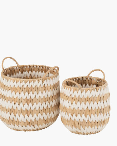 Hand woven natural and white grass basket with handle on white background