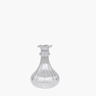 Glass bud vase with grooves on white background