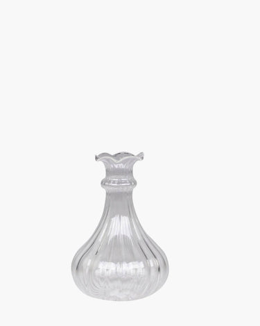 Glass bud vase with grooves on white background