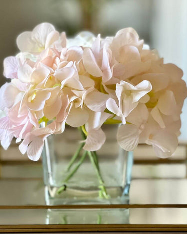 Silk flower Hydrangea arrangement in cubed glass vase in lifestyle photo
