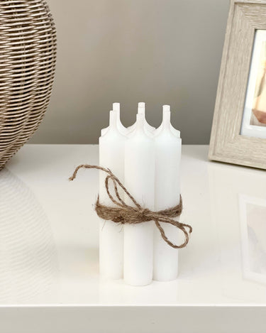 bunch of  7 short white dinner candles in lifestyle photos