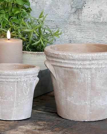 Terracotta plant pots with distressed look and groves at the top on lifestyle background