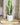 faux green plant in white pot with stone trimming in lifestyle photo