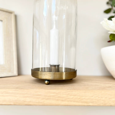 Glass and bronze candle holder on lifestyle background