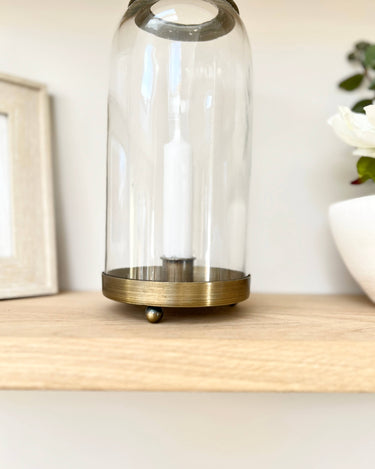 Glass and bronze candle holder on lifestyle background