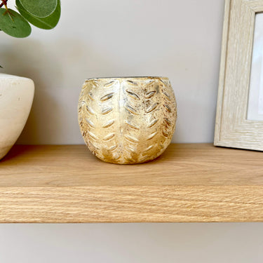 Gold etched hurricane for tealight on lifestyle background