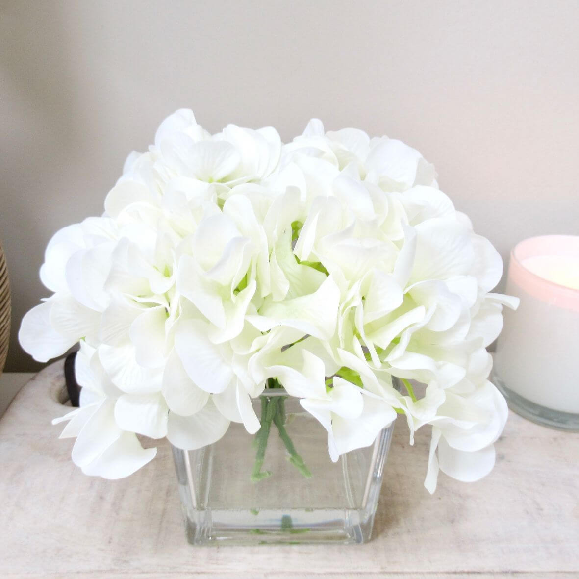 White Hydrangea in faux water in cubed glass vase
