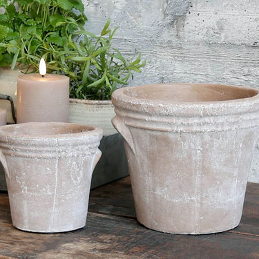 Large Terracotta plant pot with distressed look on lifestyle background