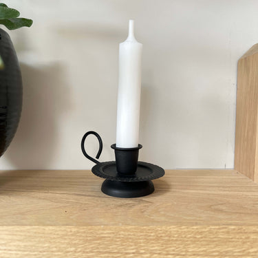 black chamberstick with handle in lifestyle background