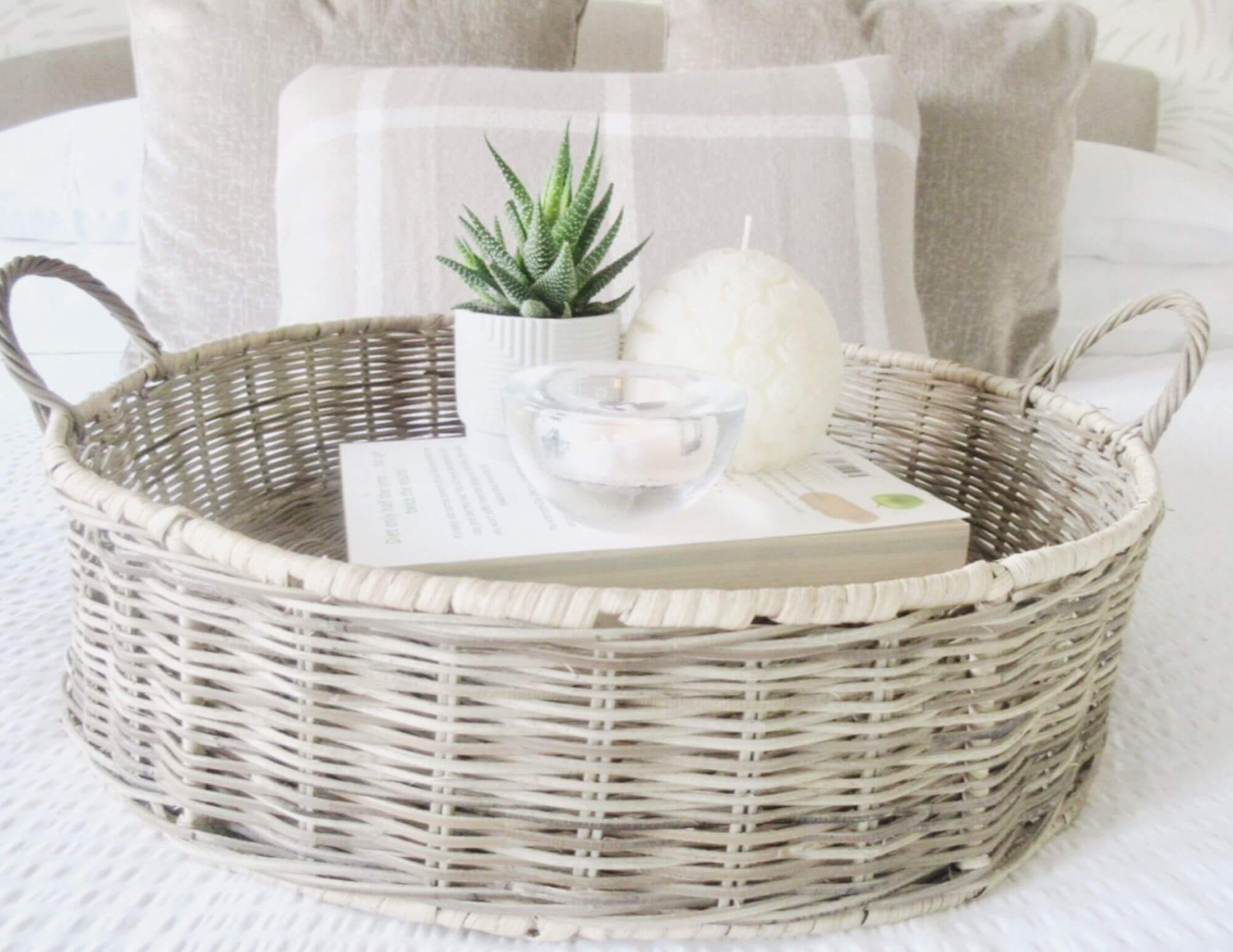 Round wicker basket with handles on lifestyle background