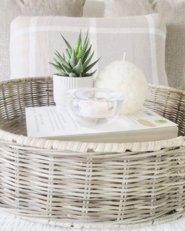 Round wicker basket with handles on lifestyle background
