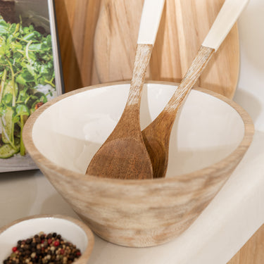 Mango wood salad bowl with white glazed interior in lifestyle photo
